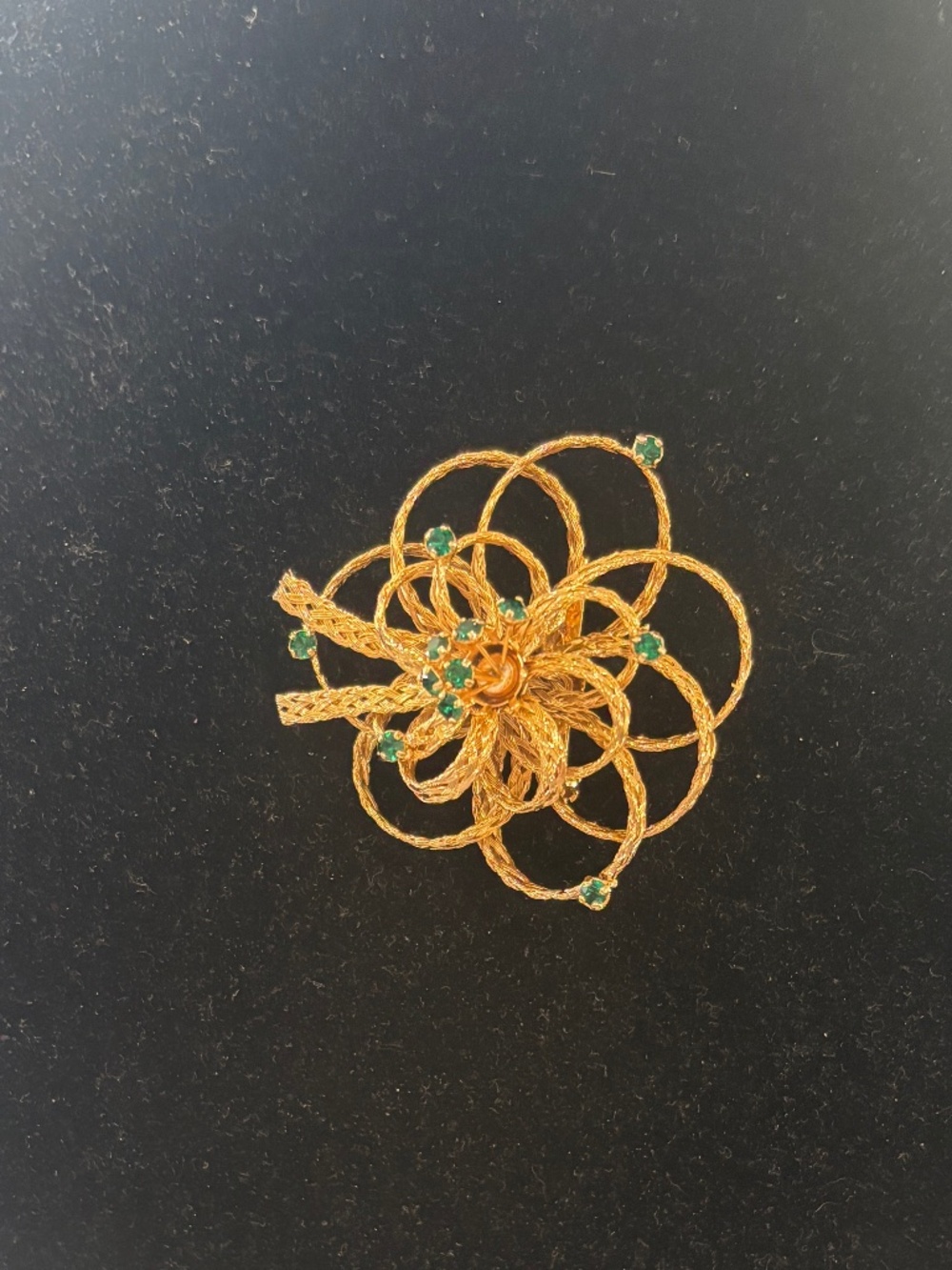 Vintage gold tone,  ribbon style floral Brooch accented with small green stones.